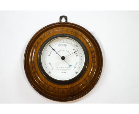 A Negretti & Zambra oak circular barometer, the dial signed and numbered 25943, 22.5cm diameter