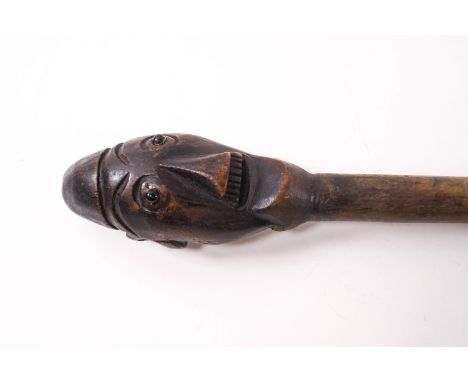 A Polynesian style walking stick, carved with the head of a man