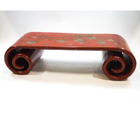 A Chinese lacquered hardwood low table with scroll ends, gilt and silvered painted peonie and butterfly decoration, 41cm high