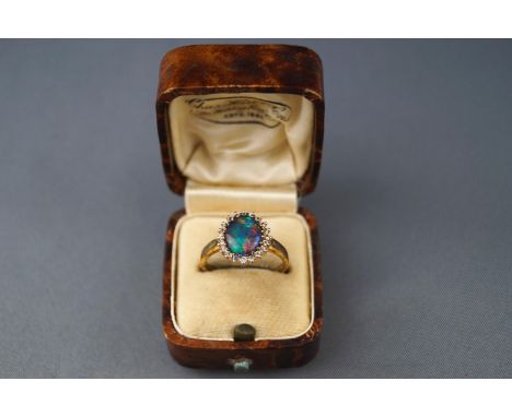 An opal-doublet and paste oval cluster ring, set in gilt stamped '925, size P, 2.8 grams gross