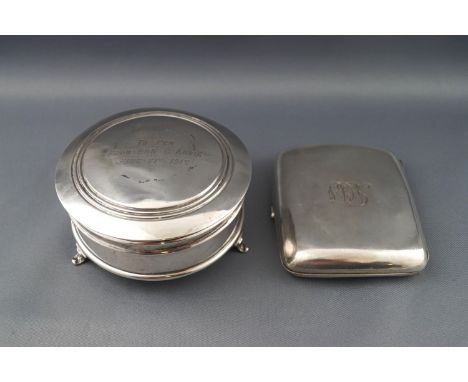 A round silver trinket box with engraved inscription to the hinged cover, on three flared feet, marks rubbed, 8.5cm diameter 