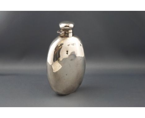 An early 20th century silver oval 6 3/4oz hip flask with a hinged twist cover, by Harry Wright Atkin, the London date letter 