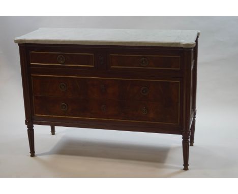 A French mahogany commode with marble top over two short and two long drawers with brass ring handles, turned and fluted supp