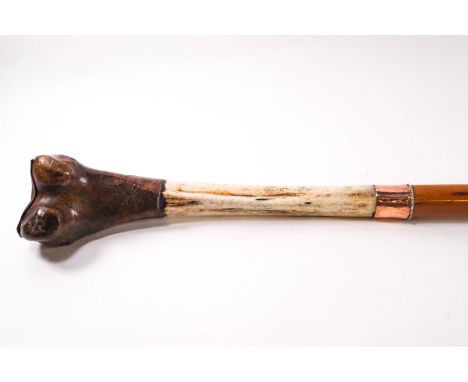 An unusual walking stick, being the tibia from a Tibetan Saint, joined to a malacca shaft (brings good luck!)