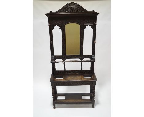 A Victorian carved oak hall stand with mirrored back, carved decoration and bobbin turned supports, 223cm high x 100cm wide x