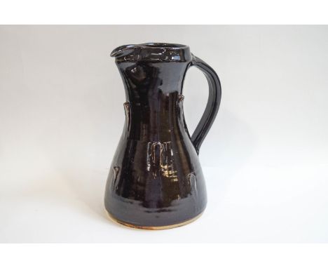 Jeremy Leach (b1941), a Lowerdown pottery stoneware jug with raised decoration and deep brown glaze, impressed seal and JL mo