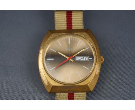 Nappey, automatic, a 1970's gold-plated tonneau-shaped wrist watch, the round golden dial with white baton numerals and hands