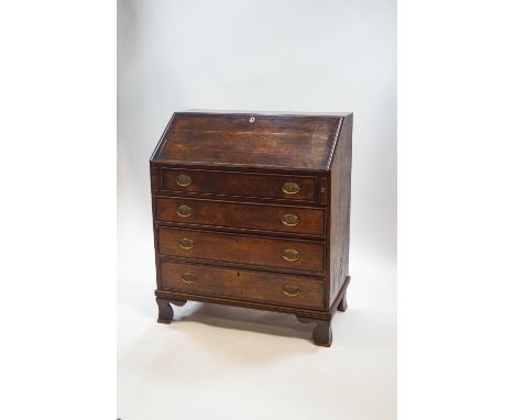 A George III oak bureau, the fall front enclosing an interior of six drawers with turned ivory handles and central compartmen