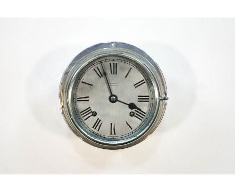 A chromed bulkhead clock by R Barrett of Ipswich, 20cm diameter at widest point, no key