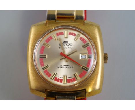 Nelson, a 1970's gold-plated and stainless steel oblong bracelet watch, the round golden dial with red baton chapter and rais