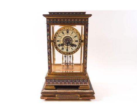 A late Victorian brass cloisonne and champleve enamel mantel clock, the painted dial with Roman numerals housing an eight day