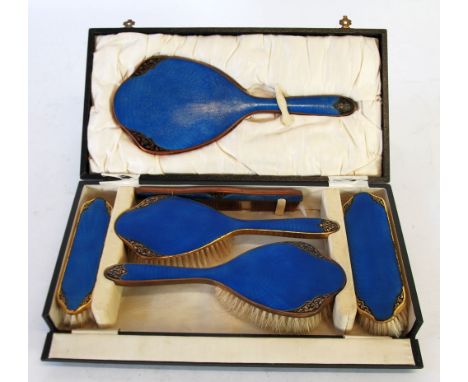 CASED BLUE GUILLOCHE ENAMEL SIX PIECE DRESSING TABLE SET, comprising hand mirror, two hairbrushes, two clothes brushes and a 