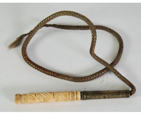 NINETEENTH CENTURY BRAIDED LEATHER WHIP with carved ivory handle and brass ferrule 