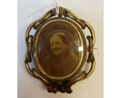 VICTORIAN GOLD PLATED OVAL BROOCH, the centre with a revolving double sided photograph locket, one side with an ambrotype por