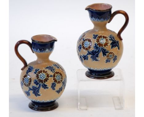 PAIR OF DOULTON SLATER'S PATENT POTTERY EWERS,  of footed bulbous form with scroll handles to the waisted necks, painted in t