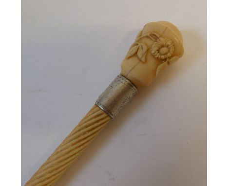 VICTORIAN CARVED IVORY WALKING STICK HANDLE; the shaft spirally fluted, the pommel carved  in relief with a floral sprig, the