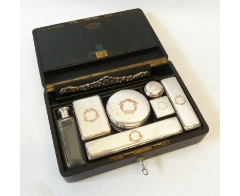 A LATE NINETEENTH CENTURY FRENCH LEATHER CASED LADY'S TOILET COMPACTUM FITTED with silver plated topped glass jars and boxes,