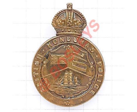 British Honduras Police helmet plate. Die-stamped brass crowned (solid) title circlet; central shield divided in three with U