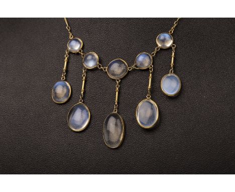 GOLD MOONSTONE NECKLACE, the five graduated round moonstones, each with a suspended oval moonstone section, on a chain marked