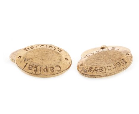 PAIR OF GOLD CUFFLINKS, of oval form, each with 'Barclays Capital' to the edge, plain to the centre, 21mm long, in nine carat