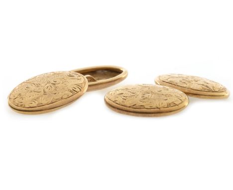 PAIR OF EARLY TWENTIETH CENTURY CUFFLINKS, each of oval form and with engraved scrolling motifs, marked 18, 6.1g gross