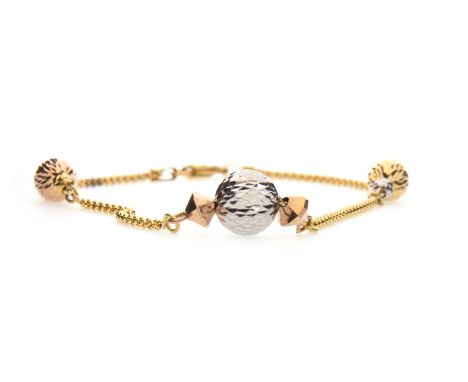 TRI COLOUR BRACELET, set with three faceted spheres, one in white, yellow and rose gold, to a yellow gold chain, marked 750, 