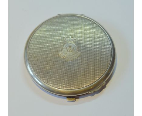 Silver engine-turned circular compact bearing a military crest for the Royal Scots Greys to the obverse, mirrored inset to th