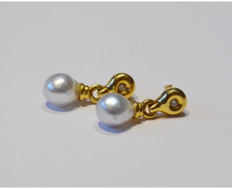 Pair of pale blue pearl drop earrings, each dependant from a diamond-set disc, in 18ct gold, 7.6g gross.