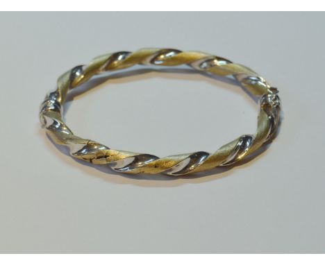 9ct yellow and white gold twisted hinged bangle, 10g.