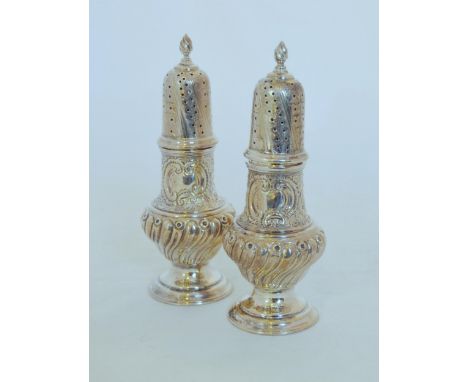 Pair of Victorian embossed silver pepperettes of Georgian baluster shape, by Haseler Brothers, London 1894, 12.5cm, 125g gros