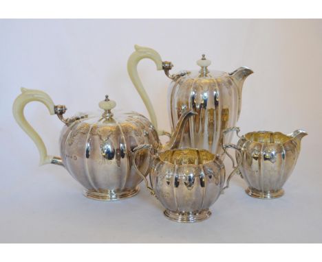 Silver four-piece tea service of early Georgian fluted globular shape with chased bands and ivory handles, (Jubilee marks),&n