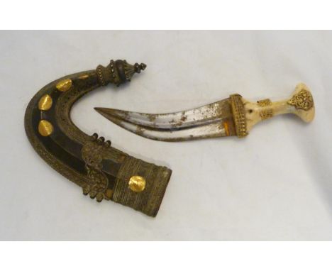 Arabic Jambiya dagger, c. late 19th century, with bone hilt bearing yellow metal appliques and ruby-coloured jewelled stone, 