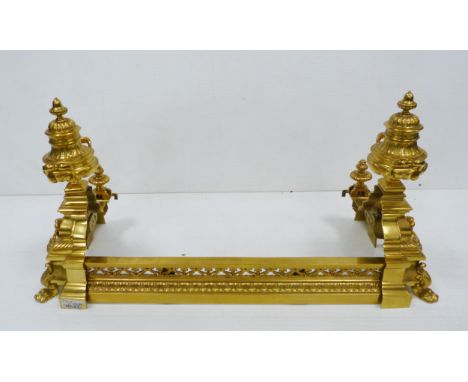 Louis XVI style cast ormolu fireside fender, the ends decorated with urns and lion masks, ornate piercing to the rail, stampe