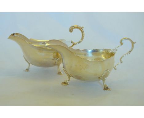 Garrard &amp; Co Ltd,&nbsp;Regent Street, London&nbsp;1967, two silver sauce boats, each with a scroll handle and shell feet,