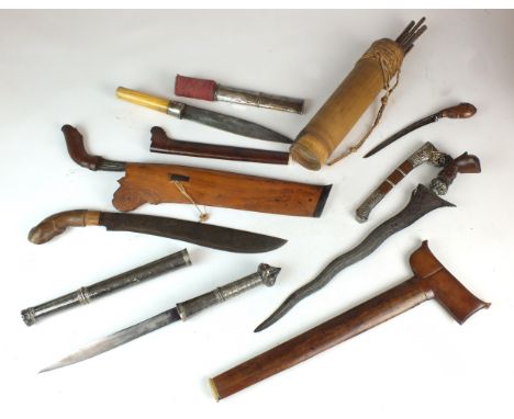 A collection of South East Asian daggers and weapons to include: a Sakai Tribe Malay Peninsular blow pipe and arrows; an Indo
