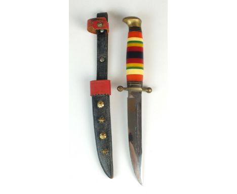 A Baron Solingen Blood Groove hunting knife, with a coloured synthetic scale handle, housed in a black and red leather sheath