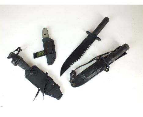 A group of assorted knives comprising a black survival-style knife with a compass in the handle and a hollow handle screw-top