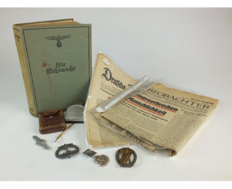 A mixed grouping of German items comprising the book 'Die Wehrmacht 1940' and four Third Reich period newspapers, a German co