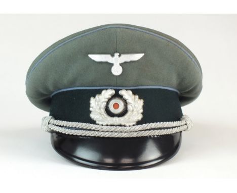 A German Third Wehrmacht Heer (Army) Transport Officer's visor cap by Schellenberg with light blue piping, metal eagle, wreat