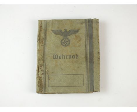 A German Third Reich Wehrpass named to Ludwig Georg Wetzel (b.1913), who served in the Army from 1940-45 (water damaged).