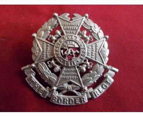 The Border Regiment Helmet Plate Centre (White-metal with red cloth backing), three lugs, second type in the design of a Malt