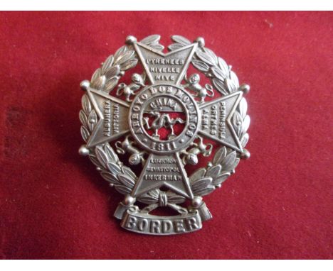 The Border Regiment Helmet Plate Centre (White-metal with red cloth backing), three lugs, second type in the design of a Malt