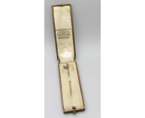 A yellow metal stick pin with white stones and heart shaped pearl, cased, 1g