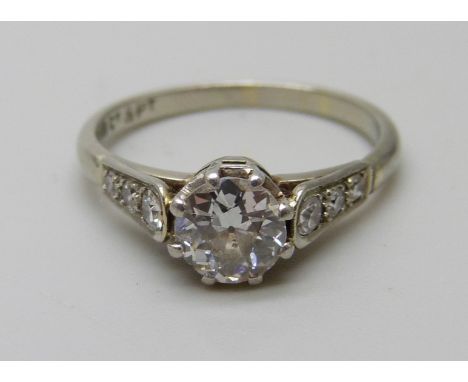 An Art Deco 18ct gold and platinum set seven stone diamond ring, main stone approximately 0.75 carat weight, 2.7g, L