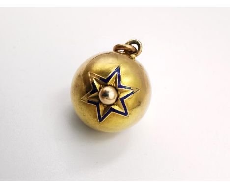 A Victorian yellow metal (tests as higher than 9ct) ball pendant with raised star design inlaid with blue enamel. Screw to th