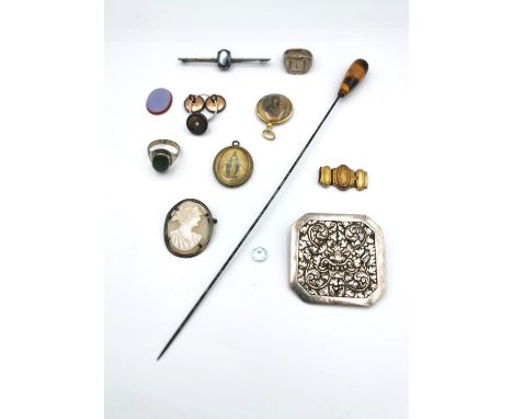 A collection of mixed costume jewellery, including a tigers eye hat pin, a white metal (tests as silver) dragon head and scro