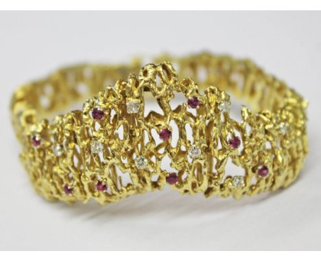 An 18ct gold diamond and ruby bracelet, length 19cm, gross wt. 53.7g.