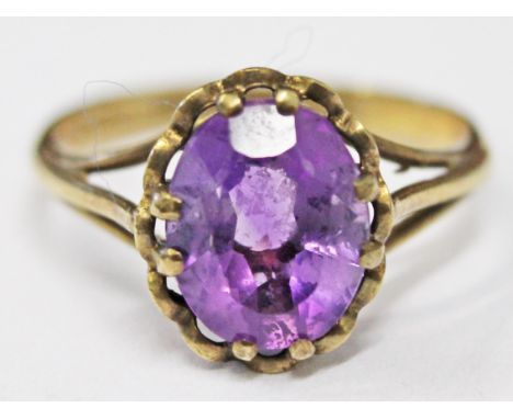 A 9ct gold ring set with a large purple stone, size O, gross wt. 2.2g.