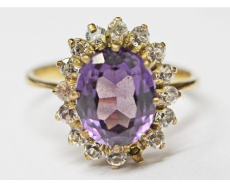 A 14ct gold ring set with a large purple stone, size M, gross wt. 3.5g.