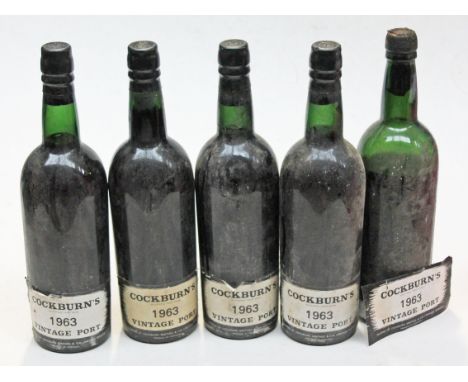 Five bottles of Cockburn's 1963 vintage port, four unopened low to high neck, one below shoulder seal broken.